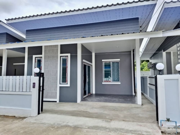 Modern gray house with a covered porch, white accents, and a concrete driveway.