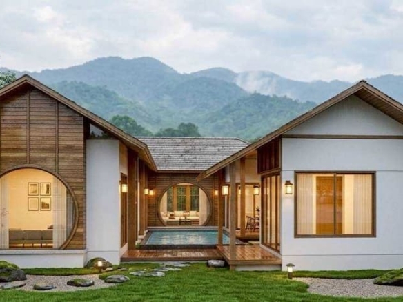Modern single-story house with circular window frames, wood accents, and a central courtyard pool, set against hills.