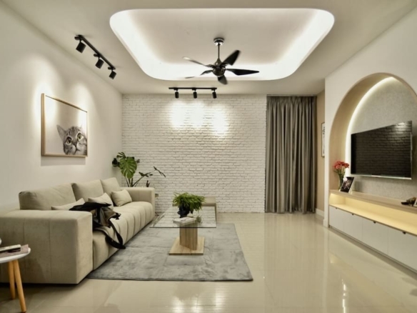Modern living room with beige sofa, glass coffee table, white brick wall, and wall-mounted TV in an arched alcove.